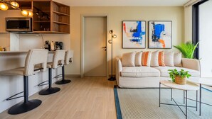 A modern living room with a sofa, chairs, a coffee table, and abstract art on the wall. - w Amazing 2BR w Balcony AC in San Francisco (Panama City)