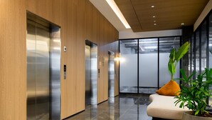 A modern elevator area with wooden paneling and a potted plant. - w Amazing 2BR w Balcony AC in San Francisco (Panama City)