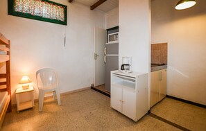 A compact kitchen with a refrigerator, microwave, and coffee maker. - 1 bedroom amazing home in CALCATOGGIO (CALCATOGGIO)
