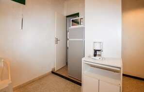 A small kitchenette with a refrigerator, microwave, and coffee maker. - 1 bedroom amazing home in CALCATOGGIO (CALCATOGGIO)