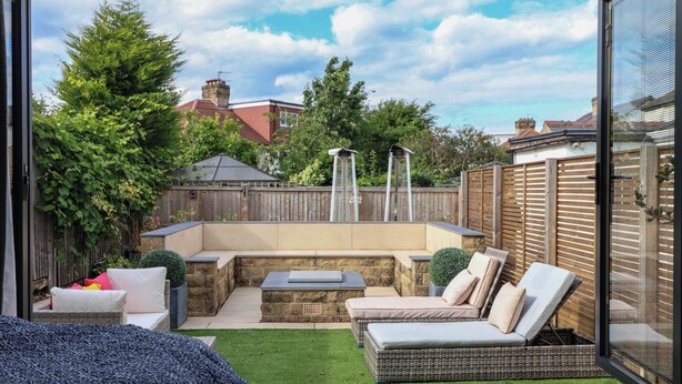 A patio with outdoor furniture, a stone wall, and a view of the neighborhood. - The Annexe (Shipley)