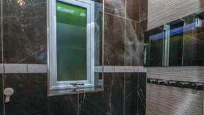 A bathroom with a mirror, a window, and a door. - The Annexe (Shipley)