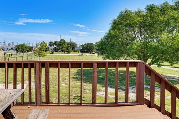 A wooden deck with a view of a grassy area and trees. - 9 Mi to Stockyards! Family Home in Fort Worth (Fort Worth)