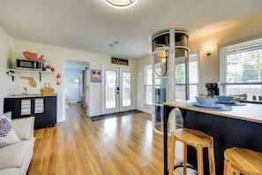 A modern kitchen with a central island, wooden flooring, and a view of the street. - Walk to the Beach! St. Augustine Group Retreat (St. Augustine)