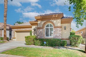 A residential house with a garage, a well-maintained lawn, and a clear sky. - Steps to Empire Polo Club: Casita w/ Pool Access (Indio)