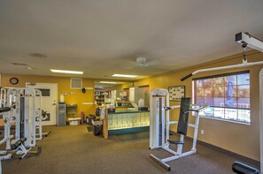 A gym with exercise equipment, a reception desk, and a window with a view of the outside. - Steps to Empire Polo Club: Casita w/ Pool Access (Indio)