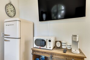 A kitchenette with a vintage refrigerator, a microwave, a coffee maker, and a clock on the wall. - Steps to Empire Polo Club: Casita w/ Pool Access (Indio)