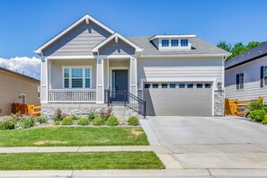 A two-story house with a front porch, a garage, and a well-maintained lawn. - Great for Families! Arvada Haven w/ Yard & Patio (Arvada)