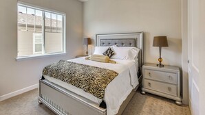 A bedroom with a bed, nightstands, a window, and a lamp. - Great for Families! Arvada Haven w/ Yard & Patio (Arvada)