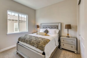 A bedroom with a bed, nightstands, a window, and a lamp. - Great for Families! Arvada Haven w/ Yard & Patio (Arvada)