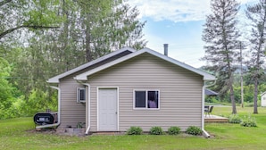 A small, single-story house with a front door, a window, and a chimney. - Creekside Retreat in Speedsville w/ Deck & Yard (Berkshire)
