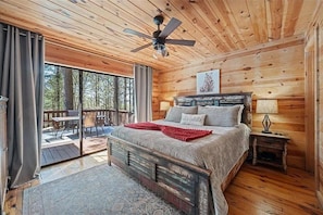 Wake up in your cozy cabin bedroom surrounded by natural wood warmth and step onto your private balcony to greet the forest morning with coffee in hand. - Whispering Pines Retreat - Covered Outdoor Lounge (Broken Bow)