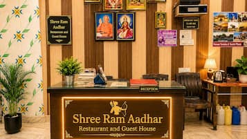 A reception desk with a sign for Shree Ram Aadhar Restaurant and Guest House.