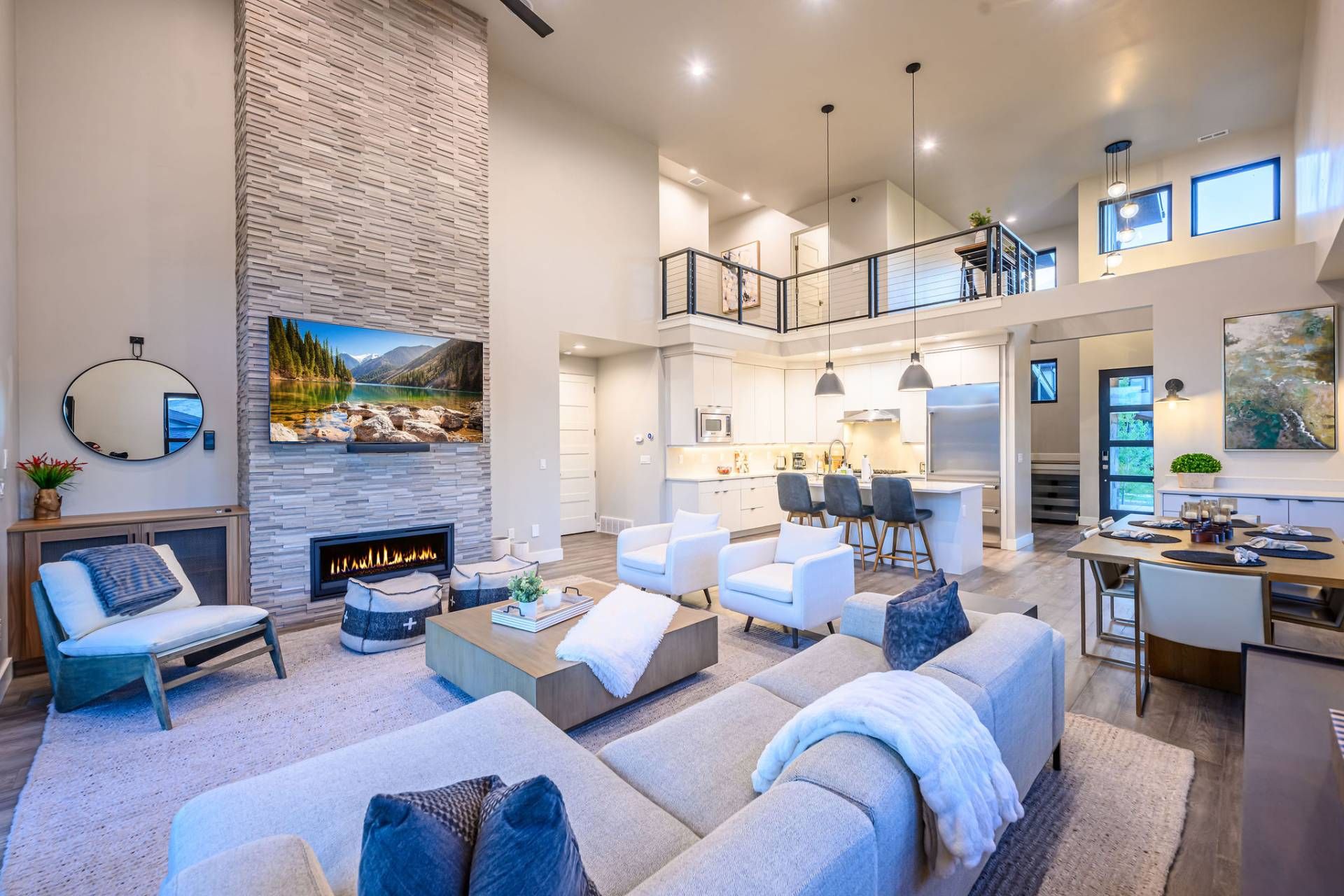 A spacious living area with a fireplace, comfortable seating, a kitchen, and a dining area.