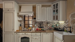 A kitchen with white cabinetry, a built-in oven, and a tiled backsplash. - Villa Dalmatia Luxury Stone Villa With Pool & Tennis (Sveti Filip i Jakov)