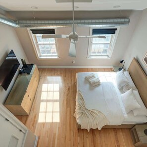 A bedroom with a bed, a desk, and a ceiling fan. - Luxury 3BR Near Rittenhouse + Roof Deck (Philadelphia)