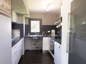 A compact kitchen with a sink, a coffee maker, and a dishwasher. - La Longère – In the Heart of a 20-Hectare Estate (Flancourt-Crescy-en-Roumois)