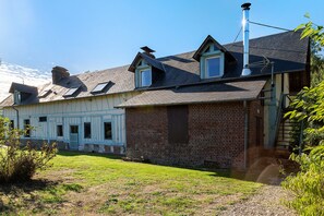 A traditional two-story house with a sloped roof, a chimney, and a small garden area. - La Longère – In the Heart of a 20-Hectare Estate (Flancourt-Crescy-en-Roumois)