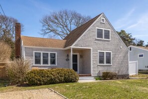 A single-story house with a gabled roof, a front porch, and a chimney. - Dharma Cottage - A Quiet 3BR Coastal Getaway in Historic Fairhaven (Fairhaven)