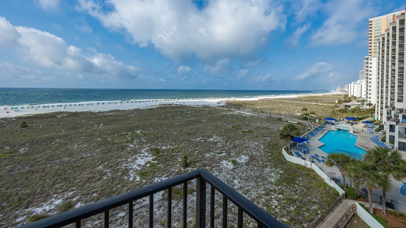 A beachfront hotel with a pool, beach access, and ocean views.