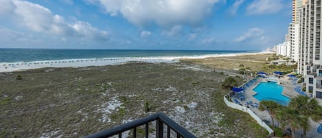 A beachfront hotel with a pool, beach access, and ocean views.