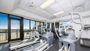 A gym with treadmills, elliptical machines, and a rowing machine. - Phoenix Vii 7102 1 Bedroom Condo (Orange Beach)