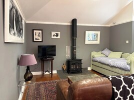 A living room with a television, a fireplace, a sofa, and a coffee table.