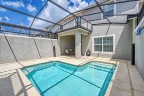 A swimming pool with a covered patio area, a small seating area, and a window with blinds. - Sl4802 - 4BR House With Pool Near Disney Area (Kissimmee)