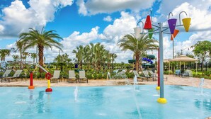 A swimming pool with water jets, palm trees, and lounge chairs. - Sl4926 - 4BR House With Pool Near Disney Area (Kissimmee)