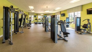 A gym with various exercise machines, large windows, and a tiled floor. - Sl3059 - 4BR House With Pool Near Disney (Kissimmee)