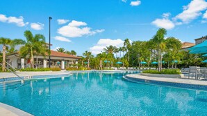 A swimming pool with clear blue water, surrounded by palm trees and lounge chairs. - Vcr4-410- 3BR Condo With Resort Access Near Disney (Orlando)