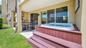 A backyard with a hot tub, wooden steps, and a patio area. - Mvy7664 - 3BR House Near Disney With Hot Tub (Kissimmee)