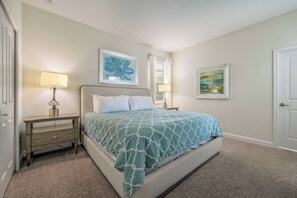 A bedroom with a bed, two bedside tables, a lamp, and two framed artworks on the walls. - Cg1569 - 5BR House With Pool Near Disney Parks (Davenport)