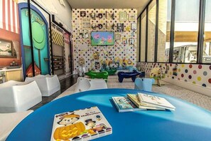 A children's play area with colorful furniture and a polka dot wall. - Mvv7482 - 3BR House Near Disney at Magic Village (Kissimmee)
