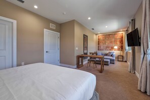 A hotel room with a large bed, a desk with a chair, a sofa, a TV, and a window with curtains. - Mvv7482 - 3BR House Near Disney at Magic Village (Kissimmee)