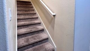 A carpeted staircase with a handrail, leading to an upper floor. - Pp2904 - 6BR House With Pool Near Disney Parks (Kissimmee)