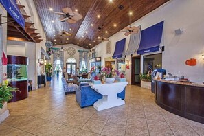 A spacious lobby with a high ceiling, wooden beams, and a reception desk. - Pp2904 - 6BR House With Pool Near Disney Parks (Kissimmee)