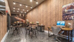 A restaurant interior with wooden walls, multiple tables and chairs, a computer desk, and a television. - Mvv7485 - 3BR House Near Disney With Hot Tub (Kissimmee)