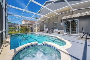 A swimming pool with a hot tub, surrounded by a covered patio area with outdoor furniture. - Hl137 - 5BR House With Pool Near Disney Area (Davenport)