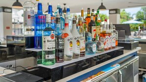 A bar area with a variety of liquor bottles displayed on shelves. - Vc11-405 - 3BR Condo With Resort Access in Orlando (Orlando)
