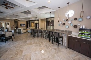 A spacious kitchen with a bar area, modern lighting, and a large window. - St4344 - 7BR House With Pool Near Disney Area (Davenport)