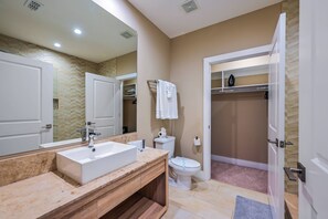 A modern bathroom with a large mirror, a sink, a toilet, and a shower area. - Mvv7561 - 4BR House Near Disney World (Kissimmee)