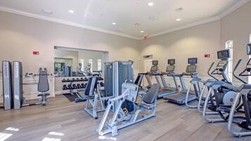 A gym with various exercise machines, treadmills, and weights.