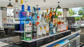 A bar area with a variety of liquor bottles displayed on shelves.