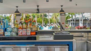 A bar area with various liquor bottles and a Tequila Patron machine.
