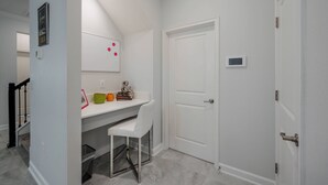 A small, clean room with a white desk, chair, and a closed door. - Cg9025 - 5BR House With Pool Near Disney (Davenport)
