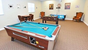 A pool table with a pool cue and balls, a smaller pool table, and two chairs. - Ow2819 - 2BR Apartment With Balcony Near Disney (Kissimmee)