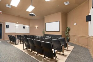 A conference room with rows of black chairs, a whiteboard, and a projector screen. - Wh2784-201 - 3BR Condo Resort Access Near Disney (Kissimmee)