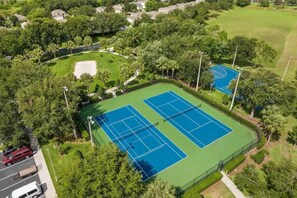 An aerial view of a tennis court complex surrounded by lush greenery and residential buildings. - Wh2784-201 - 3BR Condo Resort Access Near Disney (Kissimmee)
