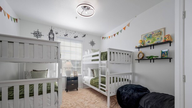 A child's bedroom with bunk beds, a desk, and a bean bag chair. - Wp304 - 2BR Fully Renovated Condo - Windsor Palms (Kissimmee)